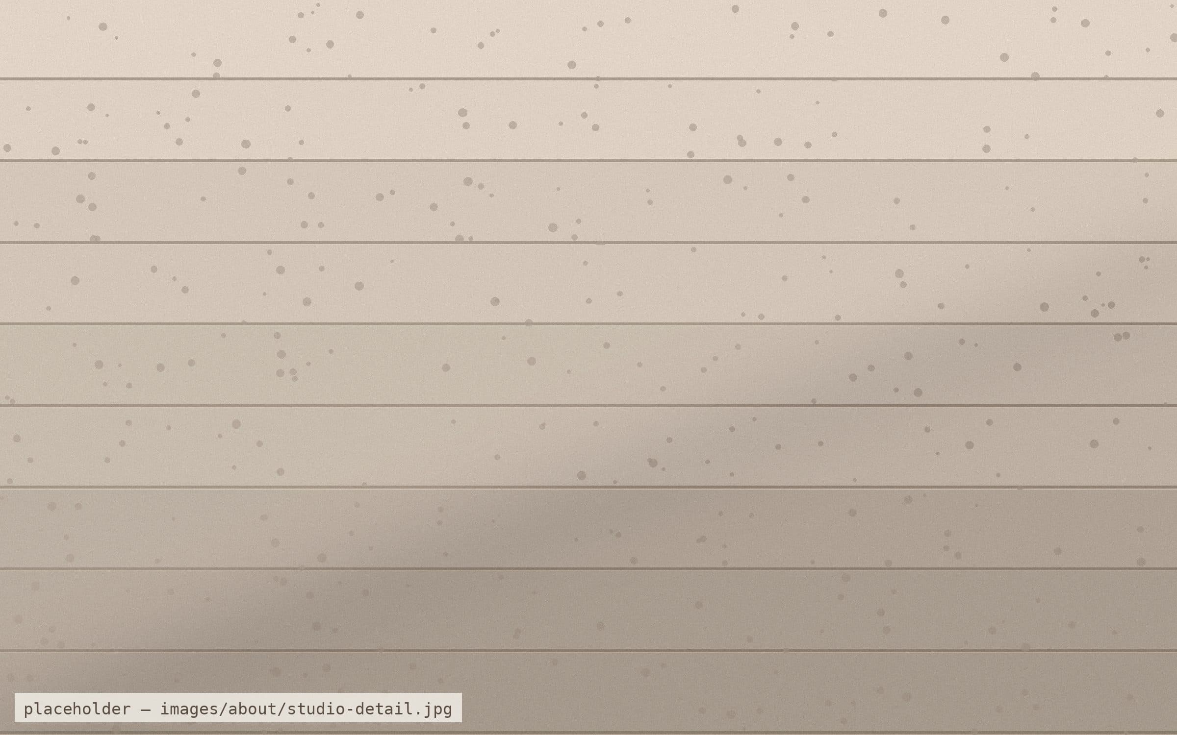 Close crop of a board-formed concrete sample under raking studio light