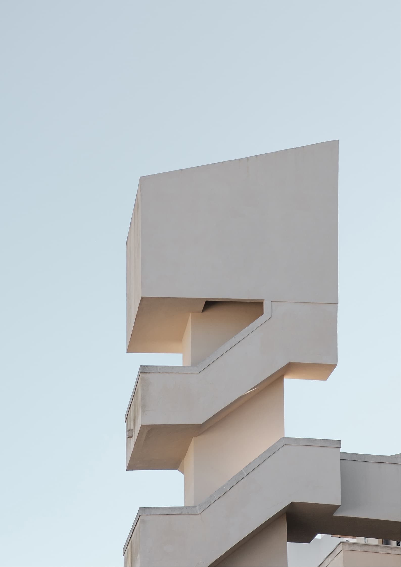 Monolith House — A rotated concrete cube with a stair cut through it and a forest pressing in.