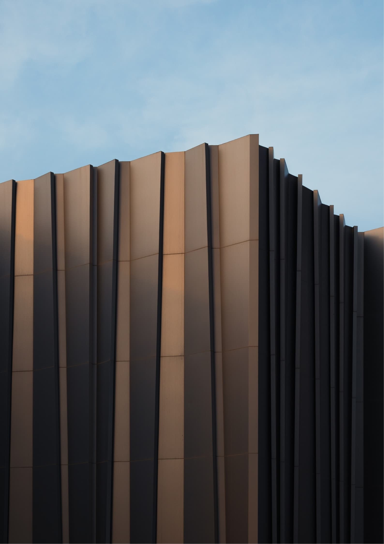 Helix Chapel — A ribbed shell mirrored in still water, so the building reads twice.